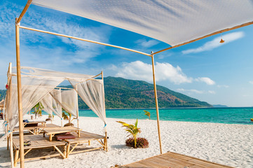 Relax on a luxury VIP beach with nice pavilions in a sunshine blue sky