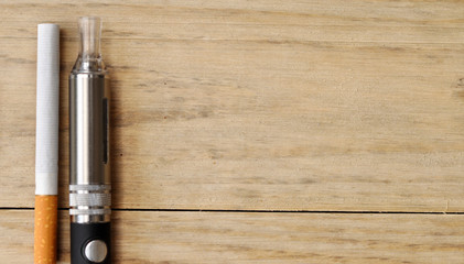 cigarette and e-cigarette on wood table © wolfelarry