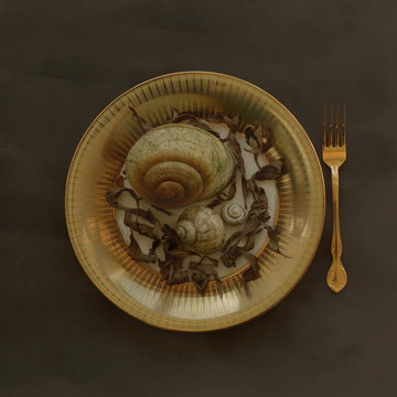 Place setting with bowl of snails and autumn leaves