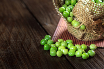 Green peas on wooden background