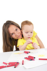 Mother and son are drawing the picture together