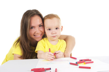 Mother and son are drawing the picture together