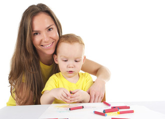 Mother and son are drawing the picture together