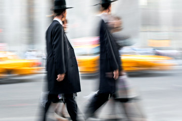 motion blurred business people walking on the street