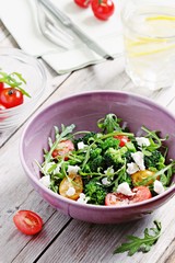 Broccoli salad with tomatoes,arugula and feta cheese.Selective focus 