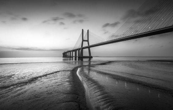 Fototapeta Vasco da Gama bridge at black and white, sunrise Lisbon
