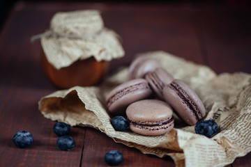 French macaroons. Coffee, chocolate macaroons with blueberry