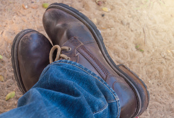 Old blue jeans and brown boots