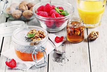 Overnight chia seeds pudding with pumpkin puree in glass jar. Healthy breakfast to go. Superfoods concept