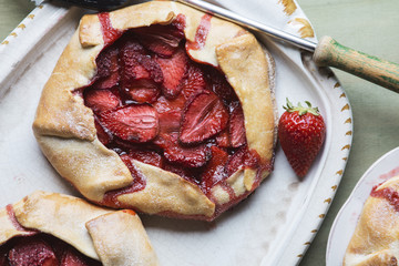 Rustic home made galettes, pastries with strawberries over green