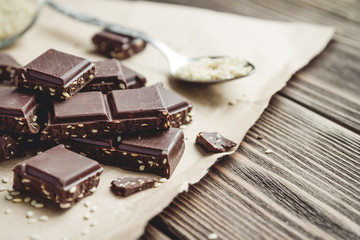 chocolate pieces with sesame on a rustic table