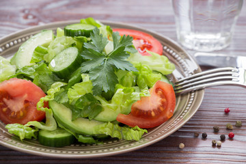 Lettuce, tomato, cucumber, avocado salad for lunch.