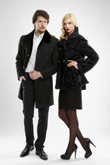stylish man and glamour woman in fur coat posing