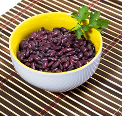 plate with haricot decorated with parsley on a rug