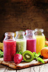 Several bottles with fruit and berry juices, vintage wooden back