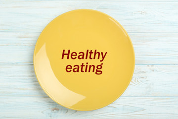 Yellow plate on a blue wooden table