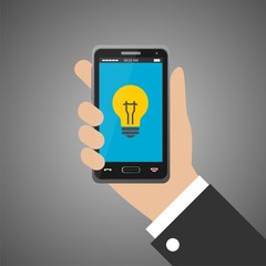 Hand holding smartphone with bulb icon