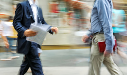 motion blurred business people walking on the street