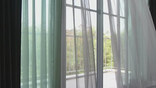 The wind blew the white curtains at the windows on deck.
