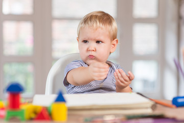 Little boy learns to lines and writes