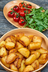 baked potatoes on a plate on old table