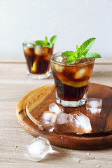 Cocktail with cola and limes slices