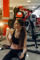 Fototapeta premium Beautiful girl with water at the gym