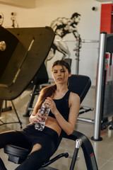 Fototapeta na wymiar Beautiful girl with water at the gym
