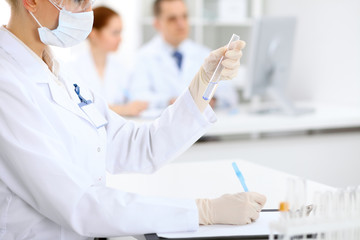 Scientific research team with clear solution in laboratory