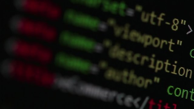 Closeup of an eCommerce website HTML source code scrolling with variable focus so different tags and keywords are highlighted on the screen.