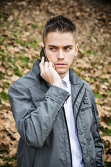 Young man in park using cell phone