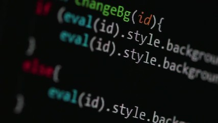 JavaScript code on dark editor background, shot close up while scrolling the page and randomly changing focus point