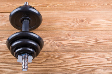 Dumbbell on wood background 