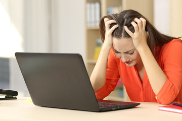 Sad freelancer working with a laptop