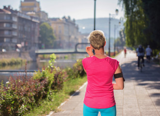 jogging woman setting phone before jogging