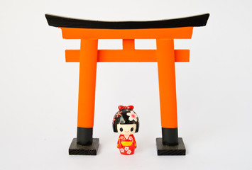 Fototapeta premium Torii gate with Japanese dolls on white background