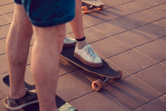 Skater's legs on longboards.