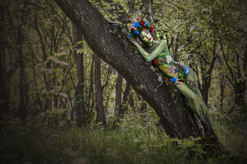 Model woman in the form of a nymph among the trees unusual fancy