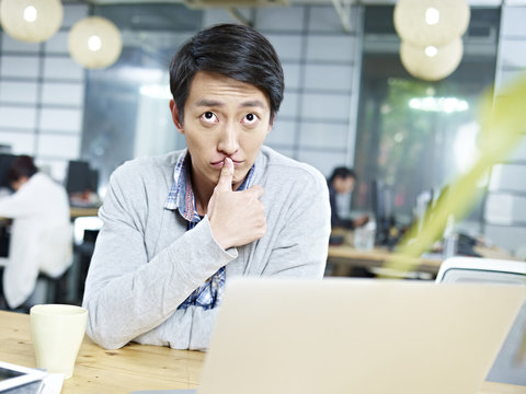 young asian business person thinking hard in office