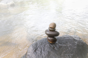 Superimposed waterfall pebble rock arranged on big stone, nature crystalline stream with pebble and soft meditation and relax mood, relax and peace background
