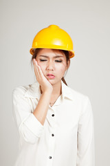 Asian Engineer girl with hard hat got toothache