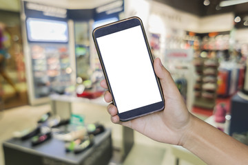 Man hand holding mobile smart phone on .Blur of city shopping pe
