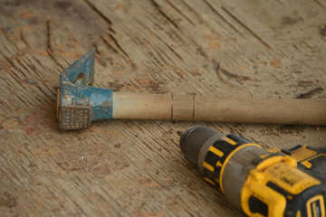 Turkish hammer and electric drill on a workbench