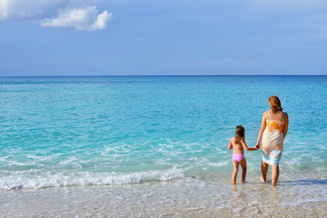 Adorable toddler girl enjoying her summer vacation at beach with