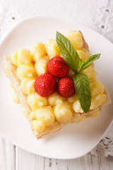 Tasty strawberry millefeuille with custard closeup. Vertical top view 
