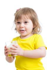Adorable child drinking milk with milk mustache holding glass of milk