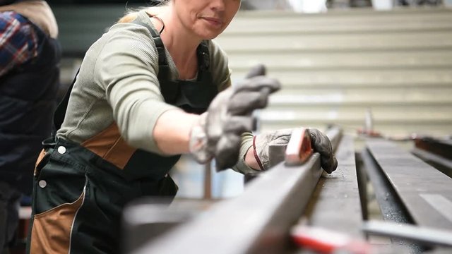 Woman working in metal industry workshop