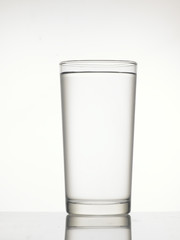 Clear glass with full of water isolated on background.
