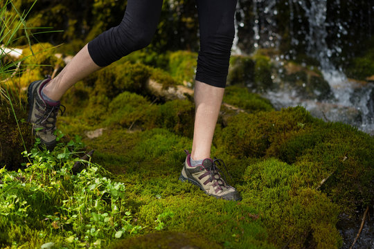 woman stepping on soft moss