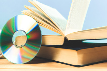 book and DVD disk as symbols of old and new methods of information storage